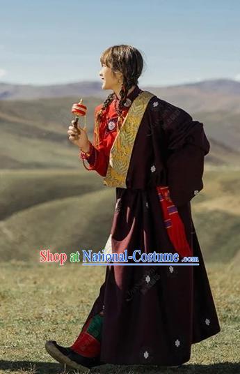 China Traditional Xizang Minority Young Lady Wine Red Tibetan Robe Zang Nationality Folk Dance Clothing